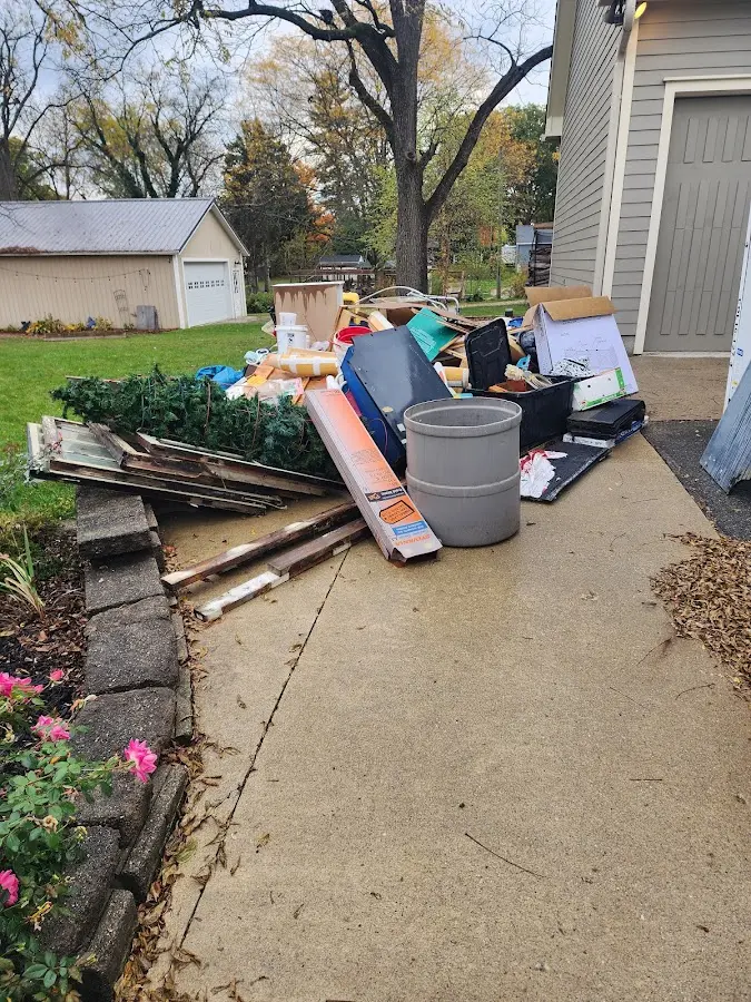Dumpster being loaded with debris for Estate Cleanout Dumpster Rental in Camp Swift